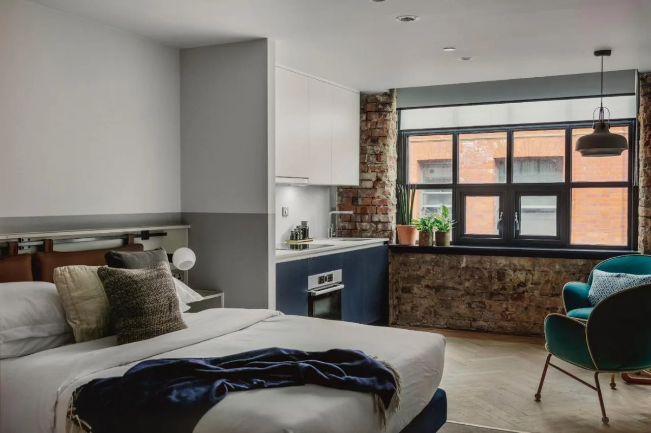 Bedroom with kitchenette at Leven Manchester Chorlton Street apartment