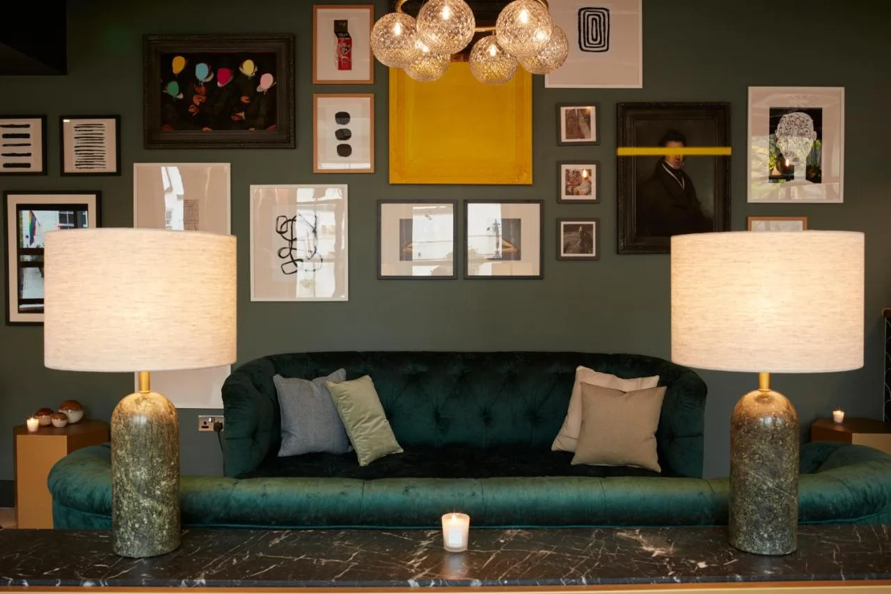 Living room with green couch and lamps at Leven Manchester aparthotel