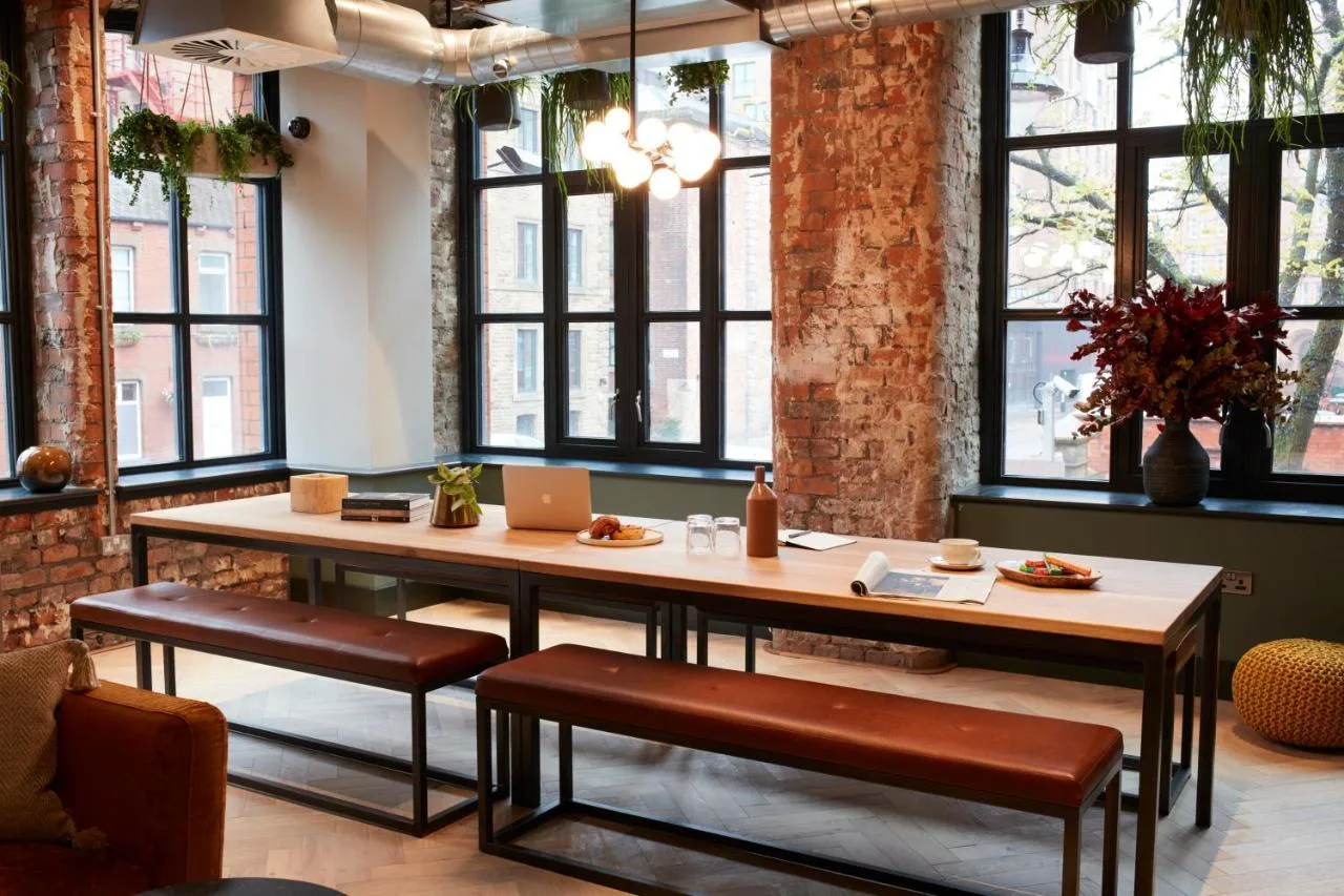 Dining space with table and benches at Leven Manchester near the Northern Quarter