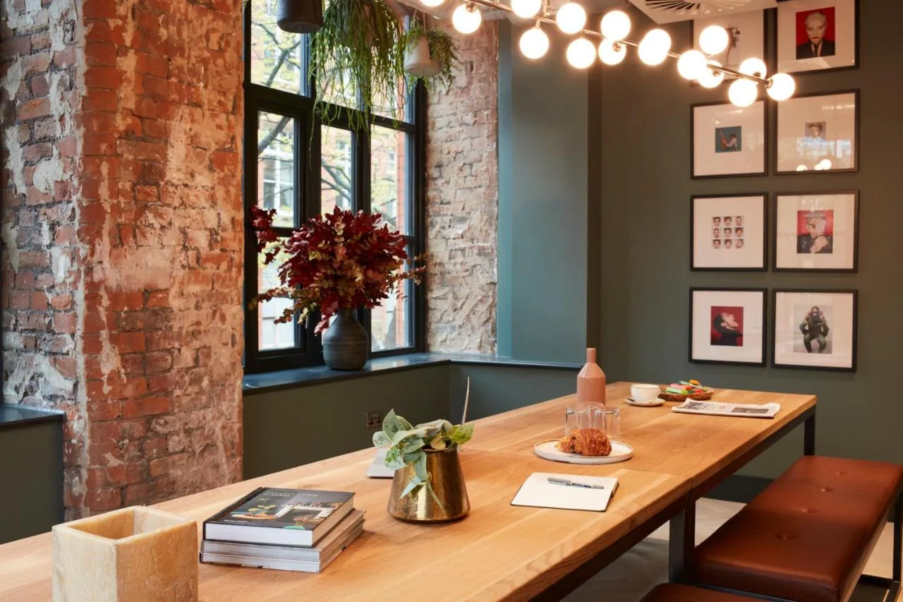 Wooden dining table by windows at Leven Manchester Manchester